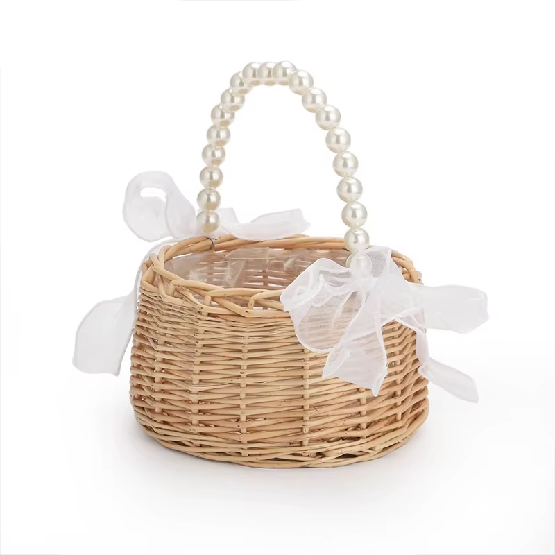 Un panier à fleurs en osier et rotin pour enfant, avec manche en perles et nœud, panier de Pâques ti