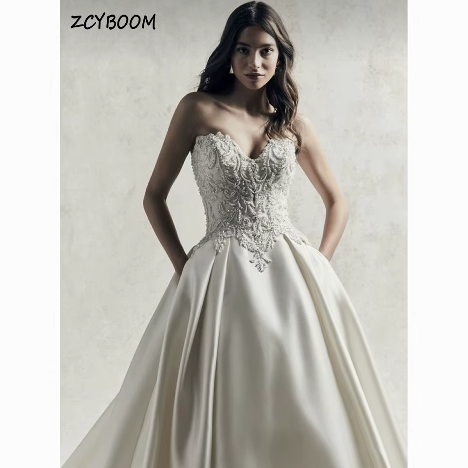 Robe de mariée personnalisée à col cœur, appliques perlées, sans manches, 2026, bustier, coupe trapè